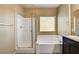 Bright bathroom featuring a tub, a walk-in shower, and dark wood cabinets at 6897 Linda Creek Ct, Las Vegas, NV 89178