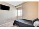 Bedroom with carpet, a mounted television, and a window with blinds at 6897 Linda Creek Ct, Las Vegas, NV 89178