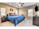 Bedroom featuring a comfortable bed, natural lighting, and simple furnishings at 6897 Linda Creek Ct, Las Vegas, NV 89178
