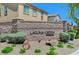 Charming stone entrance to Laguna Creek with lush landscaping and decorative rock features at 6897 Linda Creek Ct, Las Vegas, NV 89178