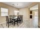 Bright dining room featuring stylish wood-look tile, a modern chandelier, and access to the backyard at 6897 Linda Creek Ct, Las Vegas, NV 89178