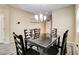 Inviting dining space with a modern chandelier, wood-look tile flooring, and neutral-toned walls at 6897 Linda Creek Ct, Las Vegas, NV 89178