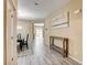 Open-concept foyer with wood-look tile flooring, console table, and view to the dining and living areas at 6897 Linda Creek Ct, Las Vegas, NV 89178