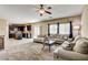 Open-concept living room showcasing a modern kitchen, comfortable sofas, and natural light at 6897 Linda Creek Ct, Las Vegas, NV 89178