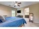 Comfortable main bedroom featuring ceiling fan, TV, and an ensuite bath at 6897 Linda Creek Ct, Las Vegas, NV 89178