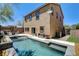 The backyard of this two-story home features a beautiful pool, patio, and well-maintained landscaping at 6897 Linda Creek Ct, Las Vegas, NV 89178