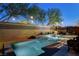 Enjoy a nighttime swim in this modern pool, enhanced by ambient lighting and a cozy outdoor lounge area at 6897 Linda Creek Ct, Las Vegas, NV 89178