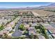 A charming neighborhood is captured from above, showcasing mature trees, beautiful landscaping, and mountain views at 7033 Twin Forks Peak St, Las Vegas, NV 89166