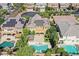 Backyard aerial showcasing pools, a tiki bar, and solar panels in a well-maintained community at 7033 Twin Forks Peak St, Las Vegas, NV 89166
