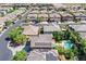 Aerial view of houses with pools, solar panels, and manicured landscaping in a residential community at 7033 Twin Forks Peak St, Las Vegas, NV 89166