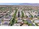 An aerial view showing a densely populated community with green spaces and symmetrical street layouts at 7033 Twin Forks Peak St, Las Vegas, NV 89166