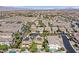 Expansive aerial view showcasing homes and desert landscape with mountain views at 7033 Twin Forks Peak St, Las Vegas, NV 89166