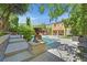 Tranquil backyard showcasing a pool, gazebo, and a beautifully landscaped yard at 7033 Twin Forks Peak St, Las Vegas, NV 89166