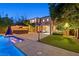 Amazing backyard with a large pool, a tiki bar, a seating area and well-manicured lawn at 7033 Twin Forks Peak St, Las Vegas, NV 89166
