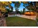 Expansive backyard with a pool, tiki bar, and lush landscaping, creating a private outdoor oasis at 7033 Twin Forks Peak St, Las Vegas, NV 89166