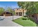 Expansive backyard featuring a covered patio, gazebo, artificial turf and mature landscaping at 7033 Twin Forks Peak St, Las Vegas, NV 89166