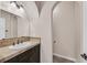 Bathroom featuring a vanity with a stone countertop and tiled backsplash, and tile floors at 7033 Twin Forks Peak St, Las Vegas, NV 89166