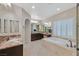 Bright, roomy bathroom features a tub, shower, and double vanity at 7033 Twin Forks Peak St, Las Vegas, NV 89166