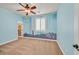 Light blue bedroom with shuttered window and a skyline accent wall at 7033 Twin Forks Peak St, Las Vegas, NV 89166