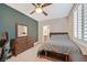 Bedroom with dresser, ceiling fan and carpet floor, with natural light from the window at 7033 Twin Forks Peak St, Las Vegas, NV 89166