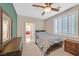 Bedroom featuring a ceiling fan, shuttered window, and neutral carpeted floors at 7033 Twin Forks Peak St, Las Vegas, NV 89166