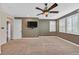 This roomy carpeted bedroom features a fan and plantation shutters at 7033 Twin Forks Peak St, Las Vegas, NV 89166