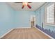 Bedroom featuring a cityscape mural on the wall, carpeted flooring, and a ceiling fan that adds personality at 7033 Twin Forks Peak St, Las Vegas, NV 89166