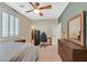Bedroom with desk, dresser, ceiling fan and carpet floor, with natural light from the window at 7033 Twin Forks Peak St, Las Vegas, NV 89166
