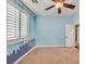 Stylish bedroom with a city-themed mural and neutral carpet offering natural light with a peaceful ambiance at 7033 Twin Forks Peak St, Las Vegas, NV 89166