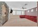 Large bonus room with stone archway, neutral carpet, ceiling fan, and plantation shutters at 7033 Twin Forks Peak St, Las Vegas, NV 89166