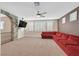 Cozy bonus room with a stone archway, ceiling fan, plantation shutters, and comfortable seating at 7033 Twin Forks Peak St, Las Vegas, NV 89166