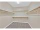 An empty walk-in closet with carpet and wooden shelving at 7033 Twin Forks Peak St, Las Vegas, NV 89166