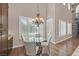 Bright dining area with high ceilings, large windows, and elegant chandelier offers a welcoming space for meals at 7033 Twin Forks Peak St, Las Vegas, NV 89166