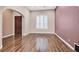 Inviting entryway with wood floors, arched doorway, and accent wall creates a warm and welcoming atmosphere at 7033 Twin Forks Peak St, Las Vegas, NV 89166