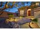 Inviting front entrance with stone accents, a garden and lush landscaping at 7033 Twin Forks Peak St, Las Vegas, NV 89166