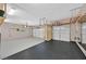 Spacious three car garage featuring wall storage and finished floors at 7033 Twin Forks Peak St, Las Vegas, NV 89166