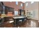 Spacious kitchen with dark cabinetry, granite countertops, island, and stainless steel appliances provides an elegant space at 7033 Twin Forks Peak St, Las Vegas, NV 89166
