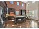 Gourmet kitchen with stainless steel appliances, granite counters, brick accent wall, and island with seating at 7033 Twin Forks Peak St, Las Vegas, NV 89166