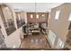 Open-concept living area with brick wall, high ceilings, wood floors, and abundant natural light at 7033 Twin Forks Peak St, Las Vegas, NV 89166