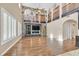 Expansive living room with a stone fireplace, high ceilings, and abundant natural light at 7033 Twin Forks Peak St, Las Vegas, NV 89166