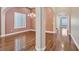 Spacious formal living room with hardwood floors, an elegant chandelier, and large windows with plantation shutters at 7033 Twin Forks Peak St, Las Vegas, NV 89166