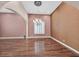 Spacious formal living room with hardwood floors, an elegant chandelier, and large windows with plantation shutters at 7033 Twin Forks Peak St, Las Vegas, NV 89166