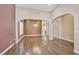 Spacious formal living room with hardwood floors, an elegant chandelier, and large windows with plantation shutters at 7033 Twin Forks Peak St, Las Vegas, NV 89166