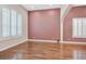 Spacious formal living room with hardwood floors, an elegant chandelier, and large windows with plantation shutters at 7033 Twin Forks Peak St, Las Vegas, NV 89166