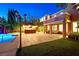Gorgeous backyard featuring a pool, bar, and covered patio, ideal for outdoor relaxation and entertainment at 7033 Twin Forks Peak St, Las Vegas, NV 89166