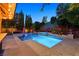 Luxurious swimming pool and spa with a tiki bar in a beautifully landscaped backyard at 7033 Twin Forks Peak St, Las Vegas, NV 89166