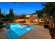 Stunning swimming pool with a waterfall feature and lush landscaping, perfect for a tranquil backyard oasis at 7033 Twin Forks Peak St, Las Vegas, NV 89166