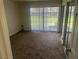 Well-lit bedroom featuring sliding glass doors and plush carpeting at 761 Bourbon St # 5, Pahrump, NV 89048