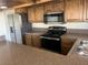 Updated kitchen with stainless steel appliances and wood cabinets at 761 Bourbon St # 5, Pahrump, NV 89048