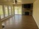 Spacious living room with a fireplace, wood-look flooring, and sliding doors at 761 Bourbon St # 5, Pahrump, NV 89048